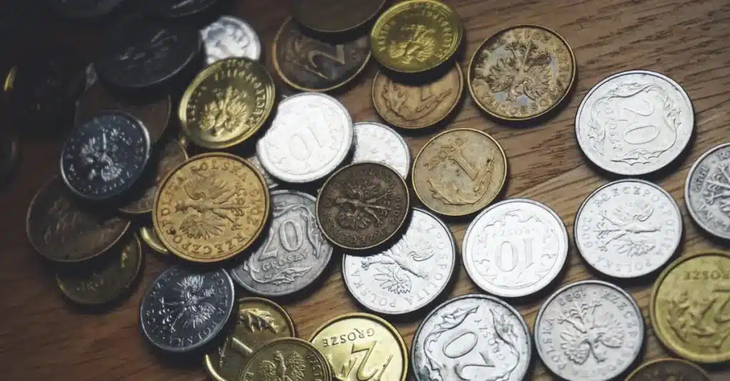 Close-up view of various Polish coins on a wooden table showcasing currency and finance concepts.