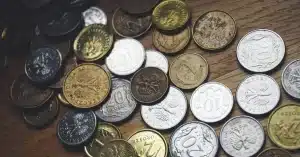 Close-up view of various Polish coins on a wooden table showcasing currency and finance concepts.